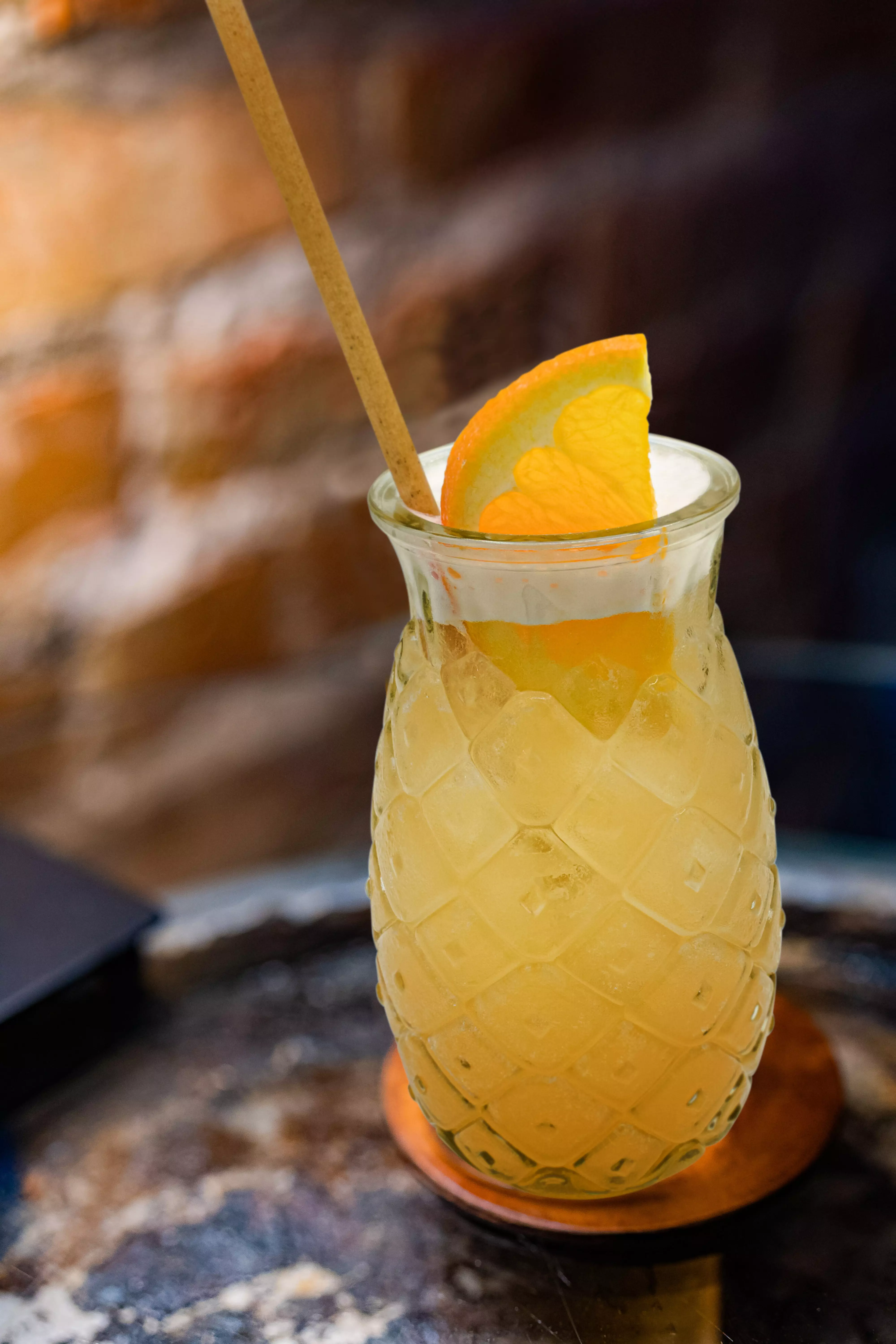Yellow cocktail with orange