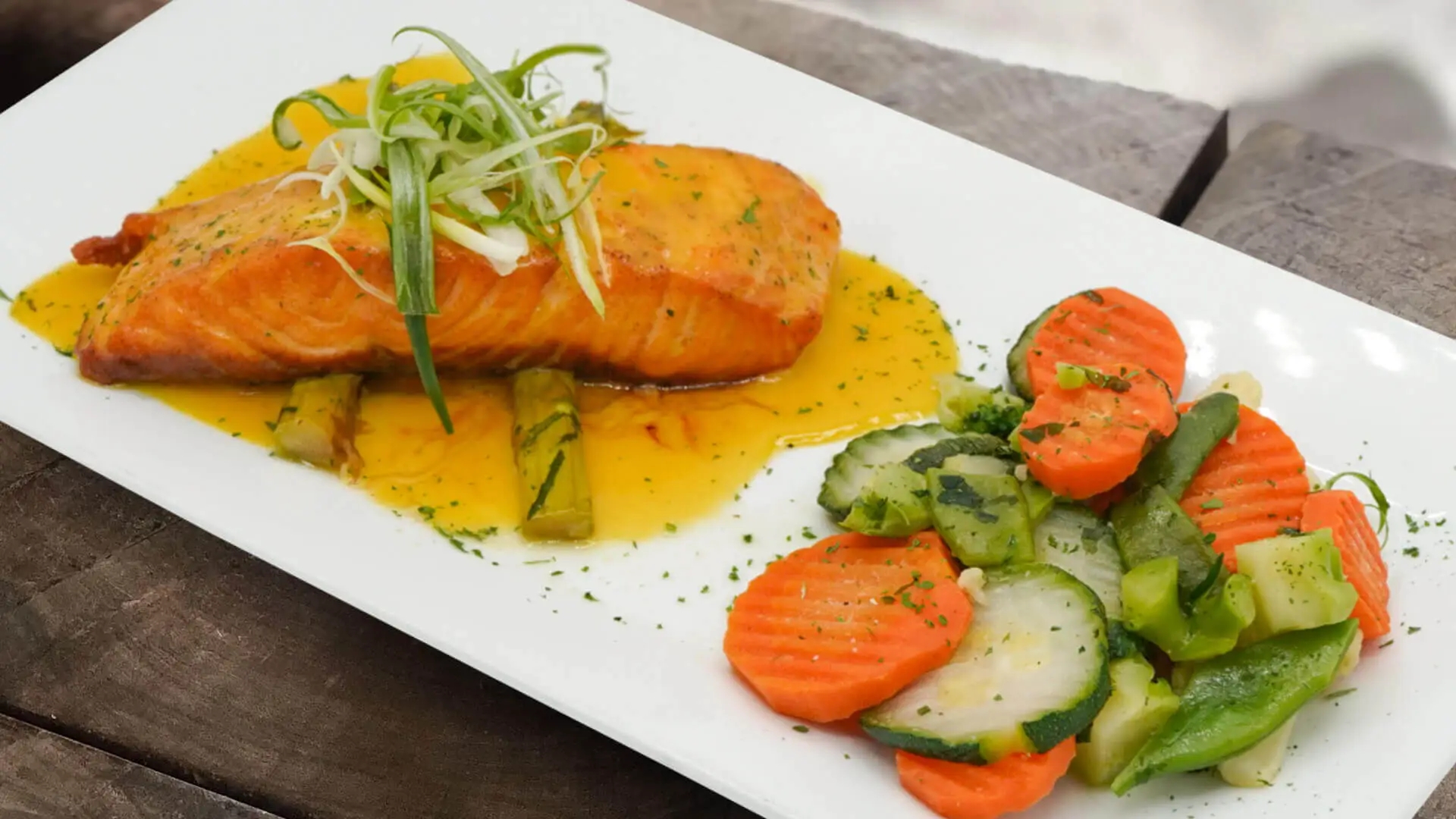 Salmon with tropical sauce on square plate